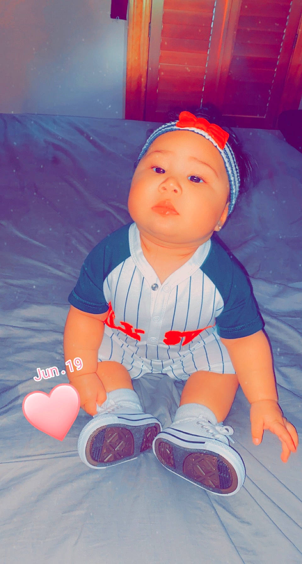 Lilian is registered to the contest to win money with this photo: azure, baby, baby_toddler_clothing, baseball_cap, carmine, child, electric_blue, flooring, fun, happy, headwear, human_body, orange, pattern, person, pink, red, sitting, sleeve, space