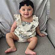 Sidak is registered to the contest to win money with this photo: baby, bodypart, chair, clothing, couch, cushion, dress, face, finger, furniture, hand, happy, head, homedecor, pants, person, photography, portrait, sitting, smile