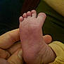 baby_foot, infant, hand, close_up, skin, toes, wrinkles, soft, cozy, warm_lighting, newborn, human, flesh, cute, small, toddler, parent, care, touch, detail