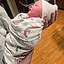 baby, blanket, cap, closeup, floor, footprints, glove, hand, healthcare, hospital, indoors, infant, medical, newborn, person, portrait, sleeping, swaddled, wooden_floor, wrapped