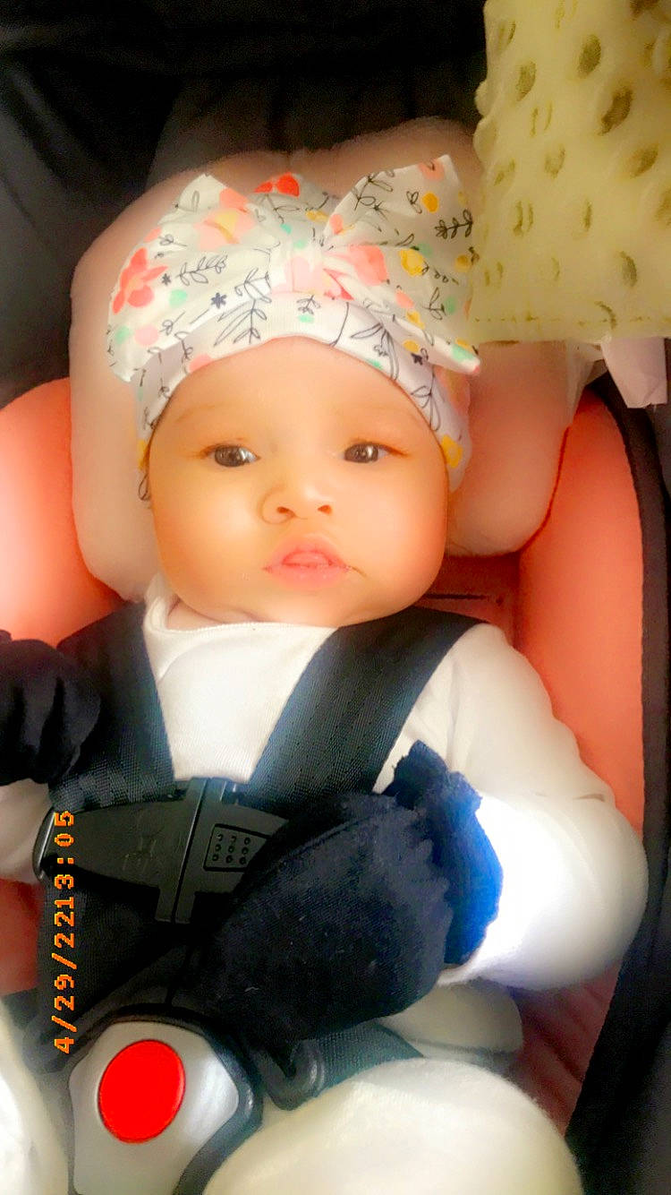 Kaia is registered to the contest to win money with this photo: arm, baby, baby_products, baby_sleeping, baby_toddler_clothing, cap, car_seat, cheek, child, eyelash, fashion_accessory, finger, fun, happy, headwear, knit_cap, mouth, nail, person, skin