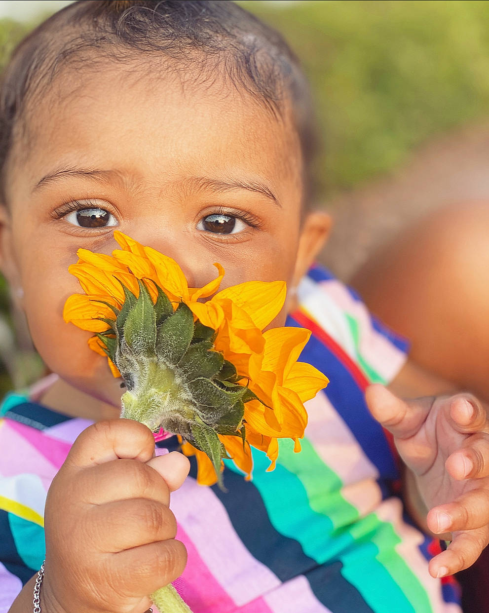 Tylah joined the competition — help win amazing prizes! eyelash, finger, fun, gesture, glove, grass, hand, happy, iris, nail, orange, people, people_in_nature, person, photograph, plant, skin, thumb, toddler, tradition