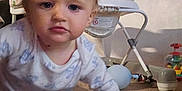 Anthony-Junior is registered to the contest to win money with this photo: baby, blond_hair, carpet, child, crawling, curious, expression, face, floor, furniture, hand, high_chair, home, indoor, infant, pajamas, person, room, toys, young_child
