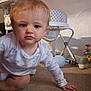 baby, blond_hair, carpet, child, crawling, curious, expression, face, floor, furniture, hand, high_chair, home, indoor, infant, pajamas, person, room, toys, young_child
