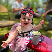 Oakley joined the competition — help win amazing prizes! baby, child, smiling, bow, headwear, pink_blanket, toy_car, outdoor, sunlight, happy, portrait, person, face, infant, clothing, playtime, grass, blurred_background, summer, cute