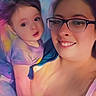 baby, woman, glasses, smile, selfie, portrait, indoor, person, child, face, colorful, pastel, artistic_filter, bed, blanket, clothing, skin, hair, happy, closeup