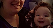 Daniel joined the competition — help win amazing prizes! woman, baby, smile, glasses, indoor, portrait, child, parent, cozy, dark, clothing, happy, face, person, baby_clothing, holding, cute, family, together, bonding