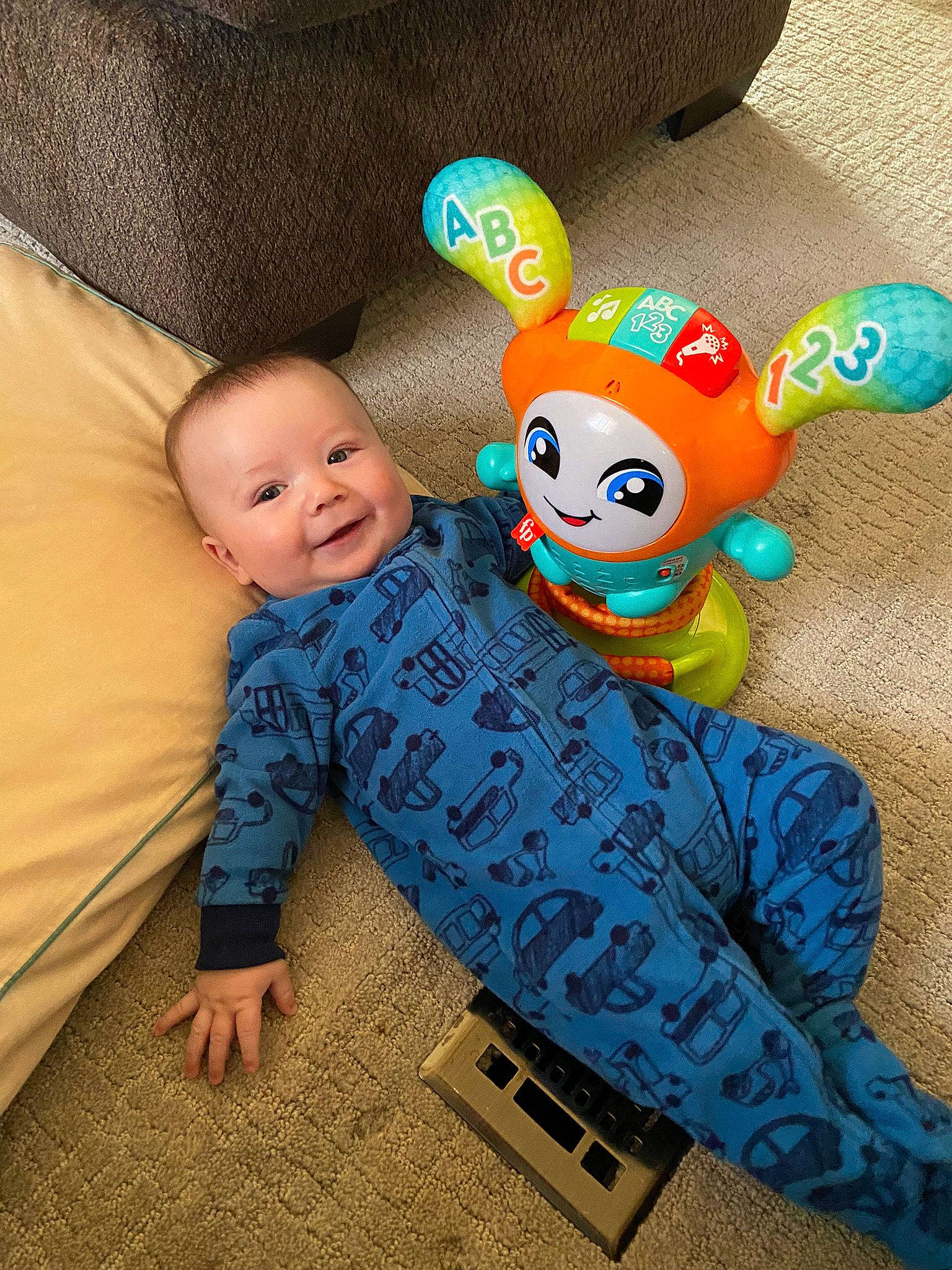 Jayden is registered to the contest to win money with this photo: baby, baby_toddler_clothing, child, comfort, couch, flooring, fun, happy, joy, linens, pattern, person, play, plush, room, sitting, smile, stuffed_toy, t_shirt, toddler
