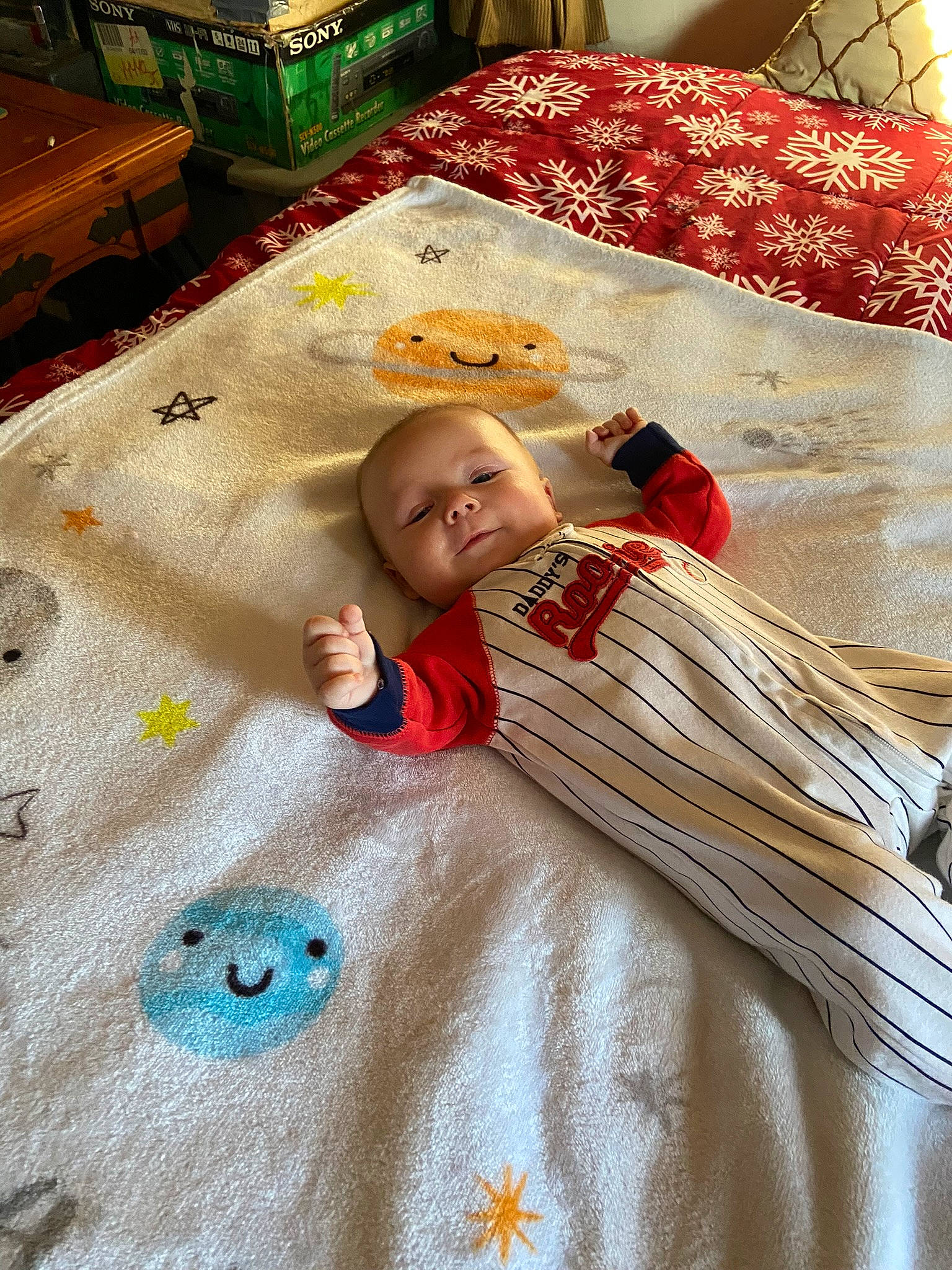 Jayden is registered to the contest to win money with this photo: baby, baby_toddler_clothing, bed_sheet, bedding, bedroom, blanket, carpet, child, comfort, event, flooring, linens, nap_mat, pattern, person, quilt, room, sleeve, textile, toddler