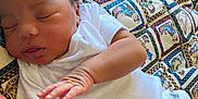 Jarvis joined the competition — help win amazing prizes! baby, newborn, sleeping, infant, white_clothing, onesie, quilt, patterned, colorful, peaceful, closeup, child, resting, soft, cute, portrait, skin, hand, lying_down, indoors