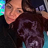 Jasko participe au concours pour gagner de l'argent avec cette photo : woman, dog, black_dog, face, pet, snuggling, cozy, blanket, indoor, portrait, relaxed, home, comfort, paw, animal, close_up, person, furniture, photography, casual