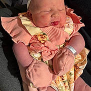Harper is registered to the contest to win money with this photo: baby, infant, sleeping, bow, headband, pink_clothing, mittens, floral_pattern, cute, chubby_cheeks, person_holding, portrait, newborn, hands, soft_lighting, indoors, peaceful, closeup, adorable, skin