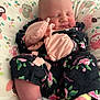 newborn, baby, sleeping, mittens, floral_clothing, pillow, owl_pattern, cozy, infant, cute, pink, soft, rest, child, portrait, indoor, comfort, peaceful, small, wrapped