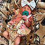 Harper joined the competition — help win amazing prizes! baby, infant, sleeping, pacifier, bow, headband, blanket, floral_dress, sock, cute, newborn, child, soft_texture, cozy, resting, indoors, person, small_hands, peaceful, wrapped