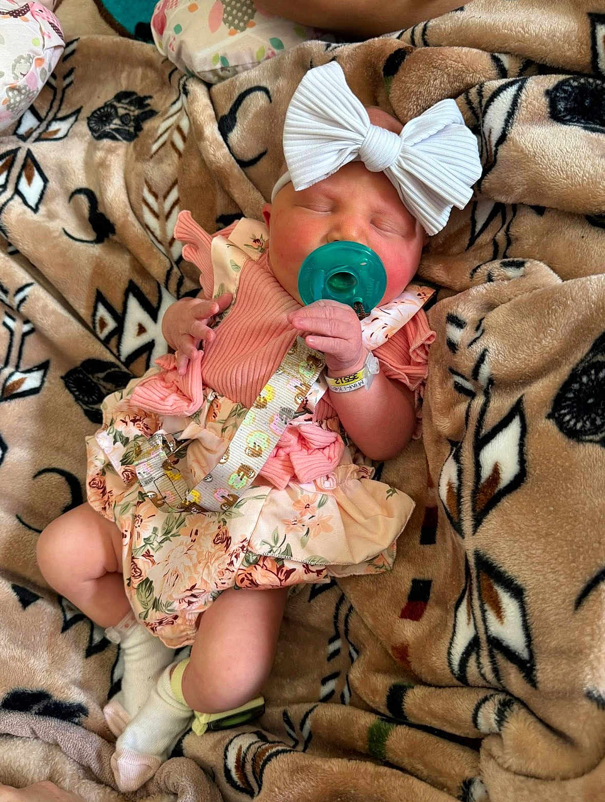 Harper joined the competition — help win amazing prizes! baby, blanket, bow, child, cozy, cute, floral_dress, headband, indoors, infant, newborn, pacifier, peaceful, person, resting, sleeping, small_hands, sock, soft_texture, wrapped