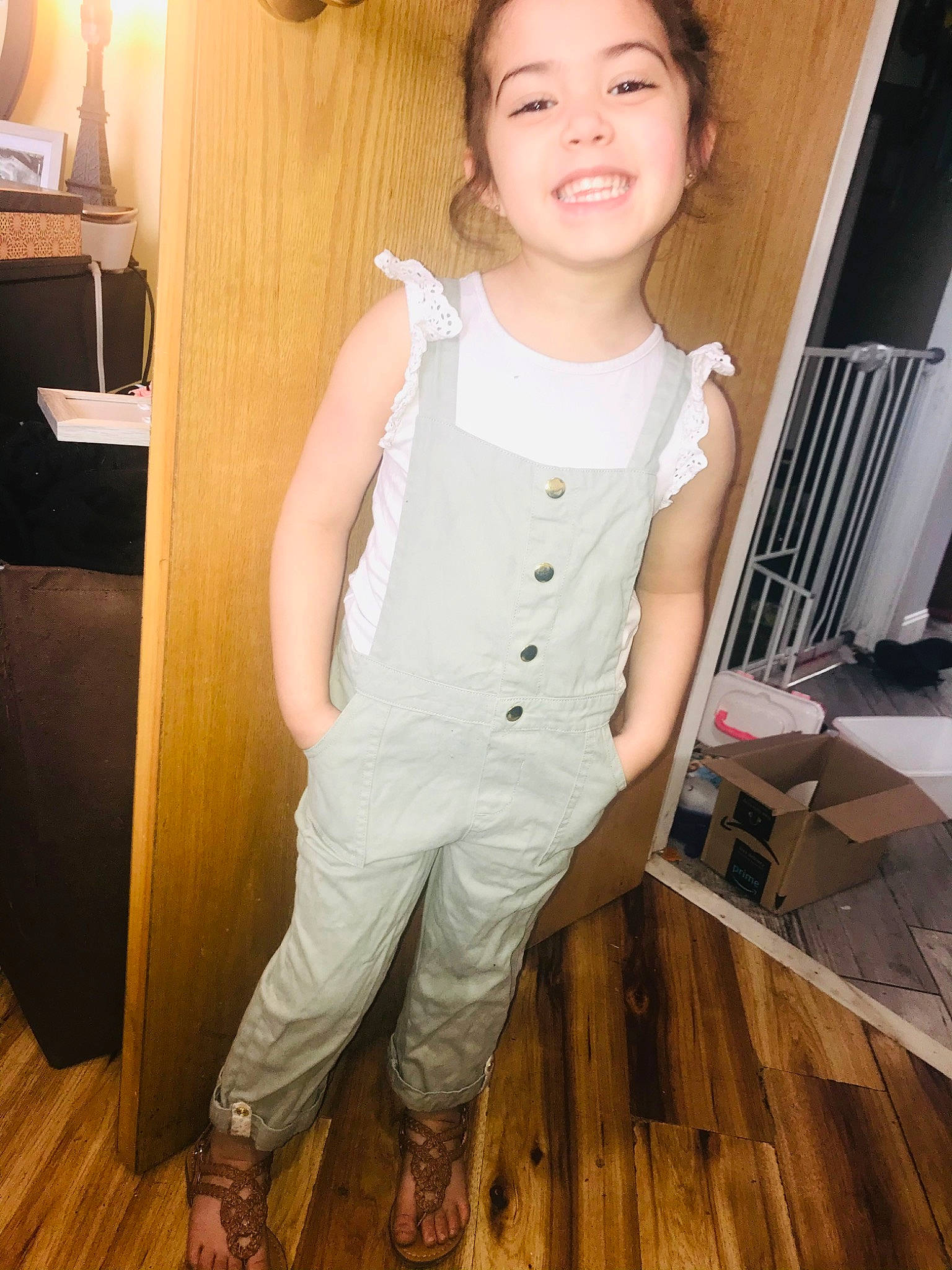 Piper is registered to the contest to win money with this photo: baby_toddler_clothing, elbow, floor, flooring, happy, hardwood, joy, knee, leg, person, skin, sleeve, smile, standing, table, thigh, toddler, trunk, waist, wood