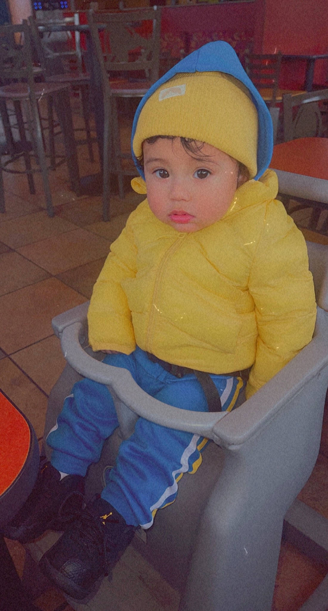 Jhair is registered to the contest to win money with this photo: baby, baby_products, baby_toddler_clothing, beanie, cap, cheek, child, electric_blue, face, flooring, fun, headgear, headwear, human_leg, knee, person, personal_protective_equipment, play, sitting, sleeve