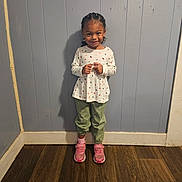 Annalise is registered to the contest to win money with this photo: child, clothing, coat, face, female, footwear, girl, hardwood, head, jeans, pants, person, photography, plywood, portrait, shoe, sitting, sneaker, standing, wood