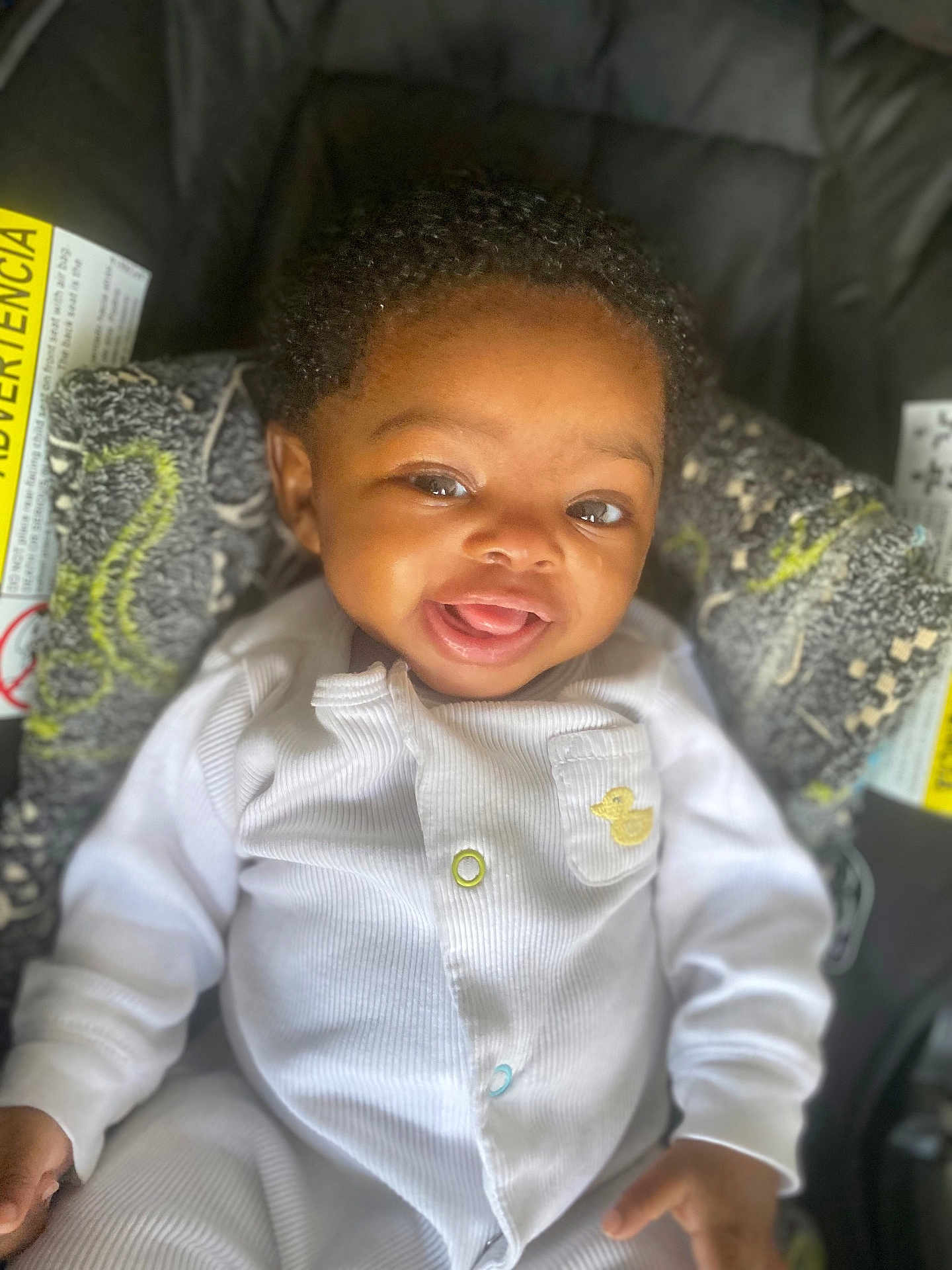 Thema-Barbara joined the competition — help win amazing prizes! baby, smiling, infant, white_onesie, curly_hair, car_seat, blanket, cute, child, portrait, happy, young_child, cozy, indoor, person, closeup, face, expression, newborn, adorable