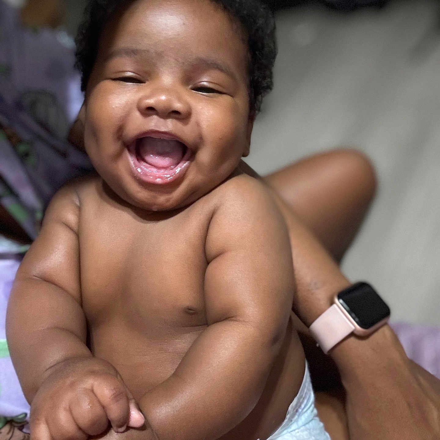 Tyreece is registered to the contest to win money with this photo: adult_hand, arms, baby, child, chubby, closeup, cute, diaper, face, hand, happy, indoors, infant, laughing, person, portrait, skin, smiling, technology, wristwatch