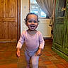 Ophelia is registered to the contest to win money with this photo: bracelet, cabinet, child, cozy, curtains, daylight, face, floor_tiles, hair, happy, home, indoor, pajamas, person, radiator, smile, toddler, walking, window, wooden_door