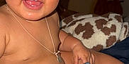 Felicity is registered to the contest to win money with this photo: baby, bed, blanket, child, clothing, cute, expression, furniture, hand, happy, indoors, infant, necklace, person, portrait, room, sitting, skin, smile, warm