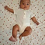 Charles a rejoint le concours — aidez-le/la à gagner de superbes lots ! baby, infant, white_onesie, lying_down, patterned_sheet, fox_pattern, curious_expression, wide_eyes, arm_outstretched, barefoot, indoors, child, cute, young, skin, head, face, legs, hands, person