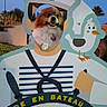 dog, fluffy, cartoon, sailor, standee, face_cutout, seagull, outdoor, evening, sky, tree, smile, pet, animal, playful, cute, fun, photo_op, sign, humor