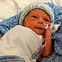 Nolan joined the competition — help win amazing prizes! newborn, baby, hospital, blanket, hat, medical_tubes, infant, bed, patient, blue_pillow, wrapped, cute, small, child, lying_down, healthcare, indoors, person, face, resting