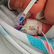 Nolan joined the competition — help win amazing prizes! newborn, baby, hospital, medical_equipment, blanket, nasal_cannula, iv_line, pacifier, infant, closeup, skin, bed, healthcare, patient, wrapped, sleeping, small, cute, fragile, care