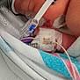 newborn, baby, hospital, medical_equipment, blanket, nasal_cannula, iv_line, pacifier, infant, closeup, skin, bed, healthcare, patient, wrapped, sleeping, small, cute, fragile, care