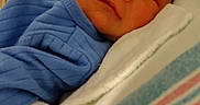 Onyx Beatty joined the competition — help win amazing prizes! baby, bed, blanket, blue_clothing, closeup, cute, face, head, hospital, indoors, infant, lying_down, medical_tube, newborn, patient, pillow, skin, sleepy, soft, tender