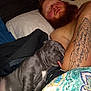 Tennessee joined the competition — help win amazing prizes! man, puppy, sleeping, bed, tattoo, beard, tongue_out, gray_dog, blanket, pillow, rest, indoor, cozy, human, pet, animal, cute, face, relax, napping
