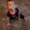 baby, pacifier, carpet, indoor, child, black_clothing, red_trim, sitting, curious, wide_eyes, floor, person, infant, cute, portrait, home, young_child, hand, foot, expression