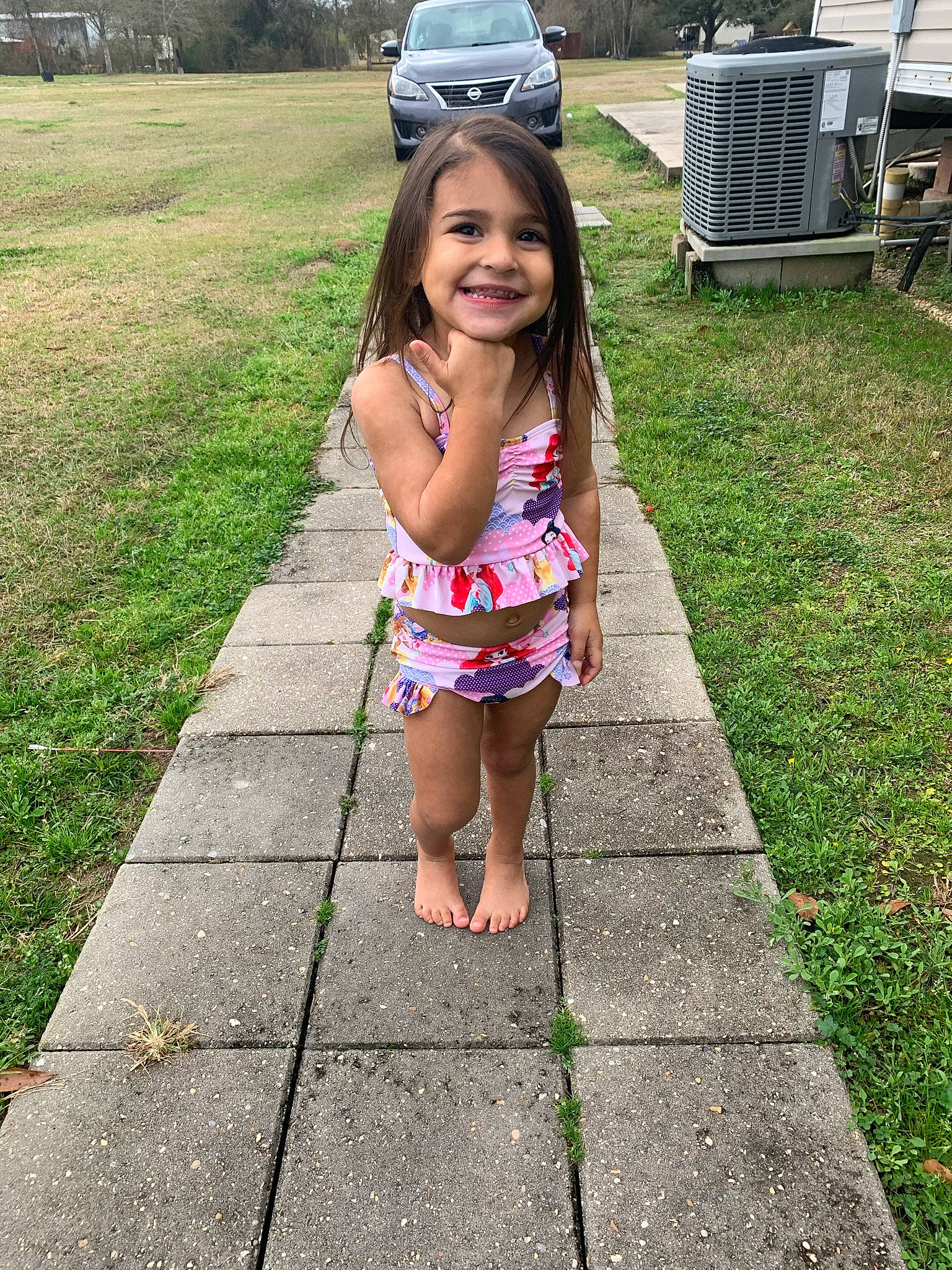 Alexa is registered to the contest to win money with this photo: asphalt, automotive_tire, clothing, eye, face, grass, happy, head, joy, leisure, motor_vehicle, people, person, plant, public_space, recreation, road, road_surface, smile, thigh