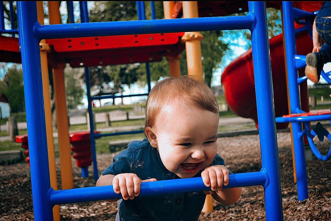 Zayden is registered to the contest to win money with this photo: baby, baby_toddler_clothing, black, blue, child, chute, city, fun, happy, leisure, nature, outdoor_play_equipment, outdoor_recreation, person, play, playground, recreation, red, snapshot, toddler