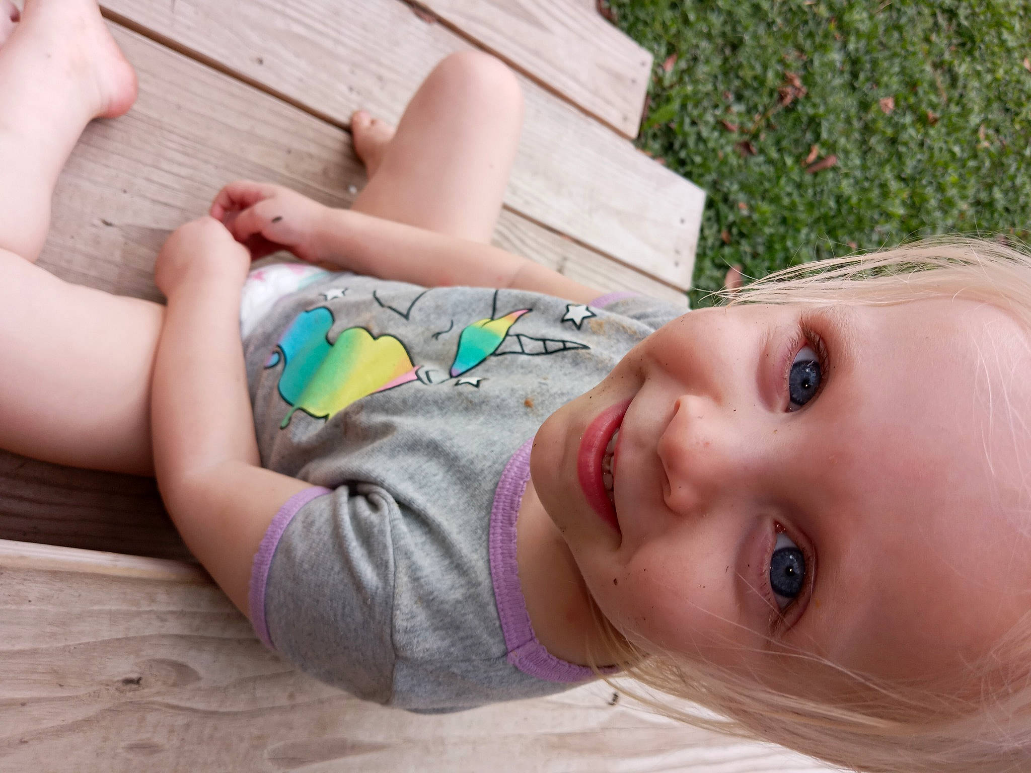 Serenity is registered to the contest to win money with this photo: arm, baby, beauty, child, eye, eyelash, facial_expression, flooring, grass, happy, joint, joy, leisure, person, plant, product, skin, smile, thigh, toddler
