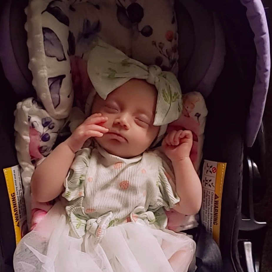 Lilana is registered to the contest to win money with this photo: baby, baby_girl, blanket, bow, car_seat, child, clothing, cushion, cute, headband, indoors, infant, newborn, pattern, peaceful, portrait, resting, sleeping, soft, toddler