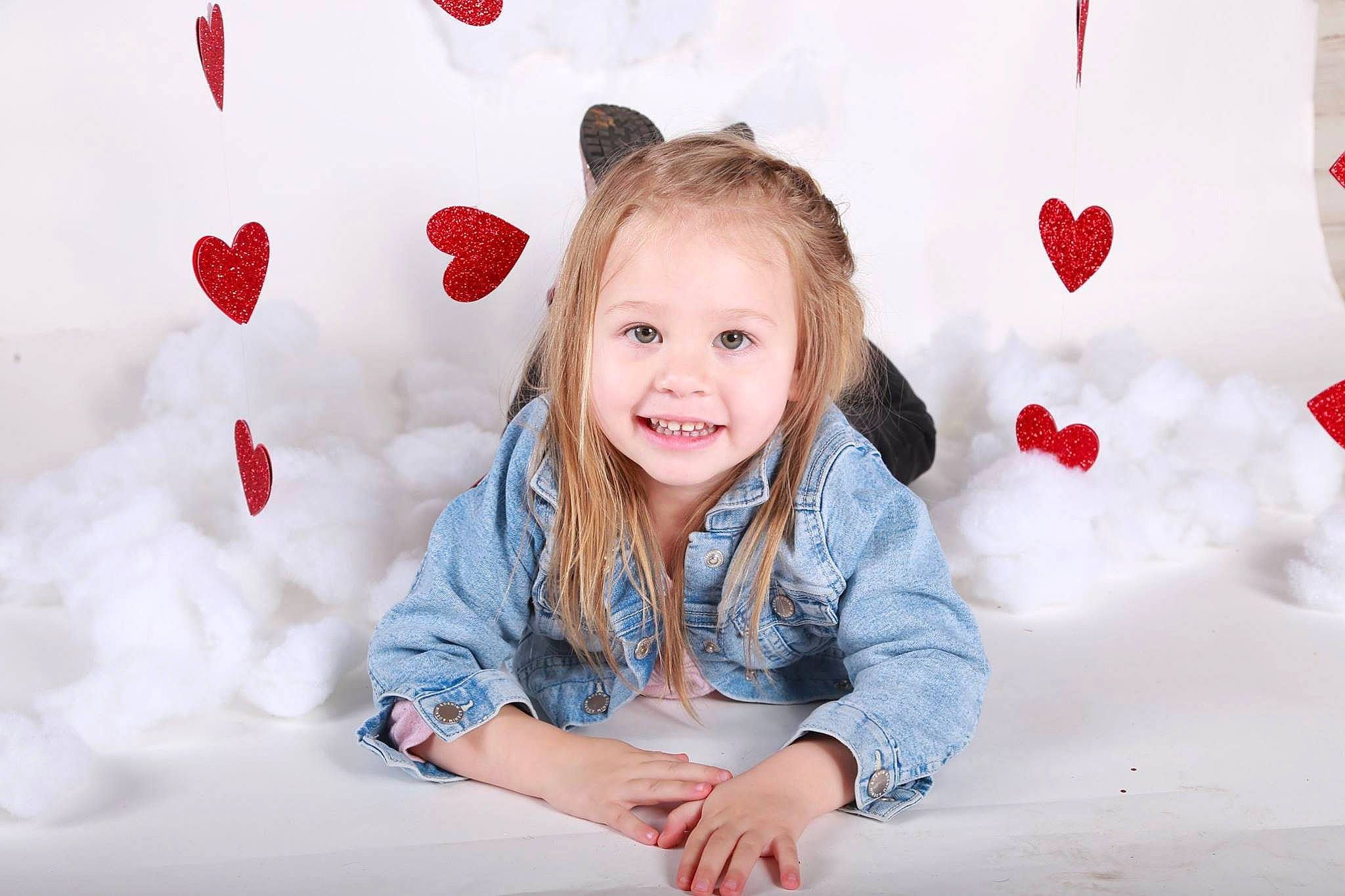 Blakelynn is registered to the contest to win money with this photo: child, child_model, ear, finger, fun, happy, heart, joy, organ, person, photography, play, portrait, portrait_photography, red, room, sitting, skin, smile, toddler
