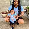 Brexton joined the competition — help win amazing prizes! toddler, woman, child, smile, outdoor, porch, concrete, brick_wall, window, plant_pot, black_shoes, blue_shirt, tattoos, black_hair, happy, family, support, casual_clothing, daylight, portrait
