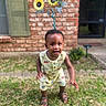 Brexton joined the competition — help win amazing prizes! brick_wall, child, clothing, door, garden, grass, greenery, happy, nature, outdoor, person, playful, portrait, sandal, smile, summer, sunflower, toddler, window, yellow_flower