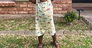 Brexton joined the competition — help win amazing prizes! brick_wall, celebration, child, dress, grass, greenery, happy, nature, outdoor, person, plant, portrait, sandals, smiling, standing, summer, sunflowers, toddler, window, yard