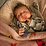 baby, sleeping, blanket, pacifier, onesie, infant, cozy, cute, child, face, hand, resting, soft, pink, patterned_clothing, indoors, portrait, peaceful, young, head