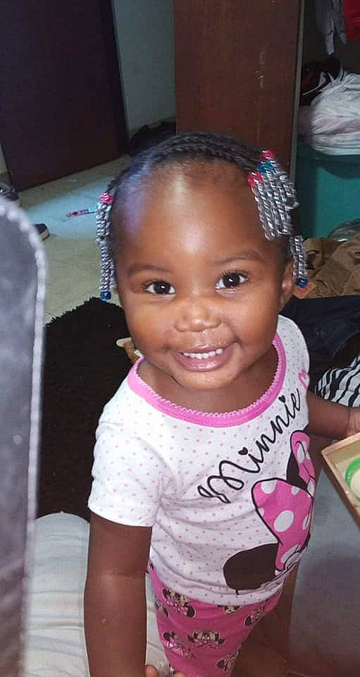 Ja'Niya is registered to the contest to win money with this photo: black_hair, cheek, child, cornrows, eyebrow, face, forehead, hair, hair_accessory, hairstyle, head, headband, joy, lip, person, pink, skin, smile, toddler