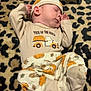baby, sleeping, cat, leopard_print, blanket, pajamas, pumpkin, animal, pet, cozy, cute, infant, rest, toddler, pattern, soft, floor, headwear, clothing, peaceful