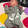 Halton joined the competition — help win amazing prizes! baby, infant, onesie, nike, socks, blanket, colorful, polka_dot, clothing, lying_down, indoor, soft, cute, child, person, portrait, small, newborn, fabric, relaxed