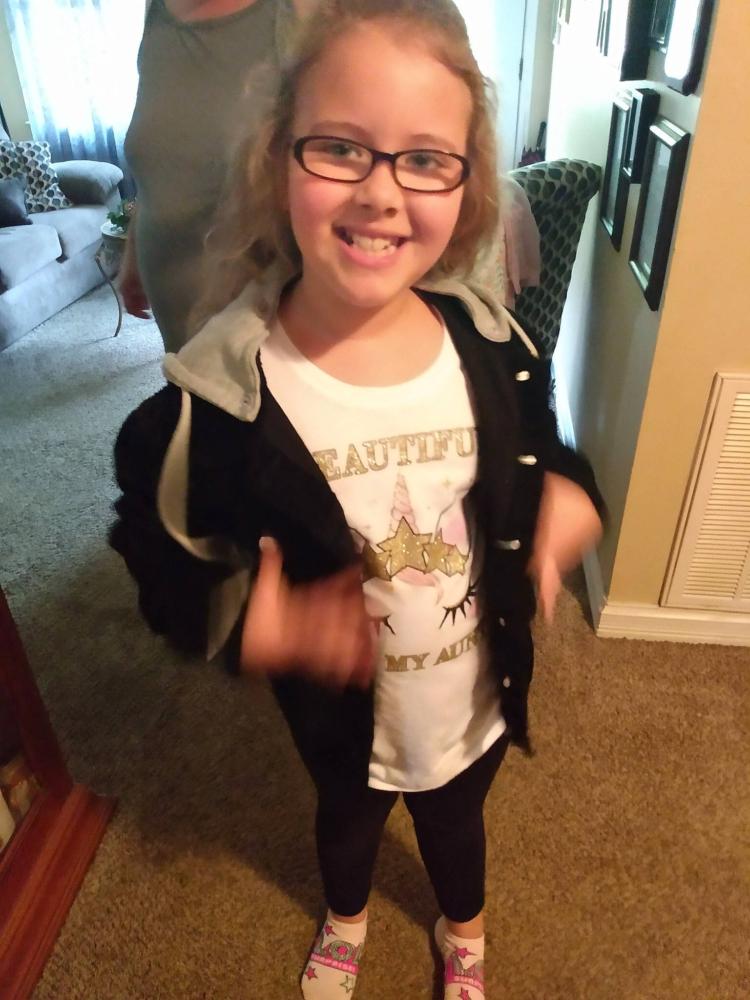 Aliezia is registered to the contest to win money with this photo: child, costume, eyewear, footwear, glasses, head, jacket, joy, outerwear, person, shoe, shoulder, skin, sleeve, smile, t_shirt, toddler, top, vision_care