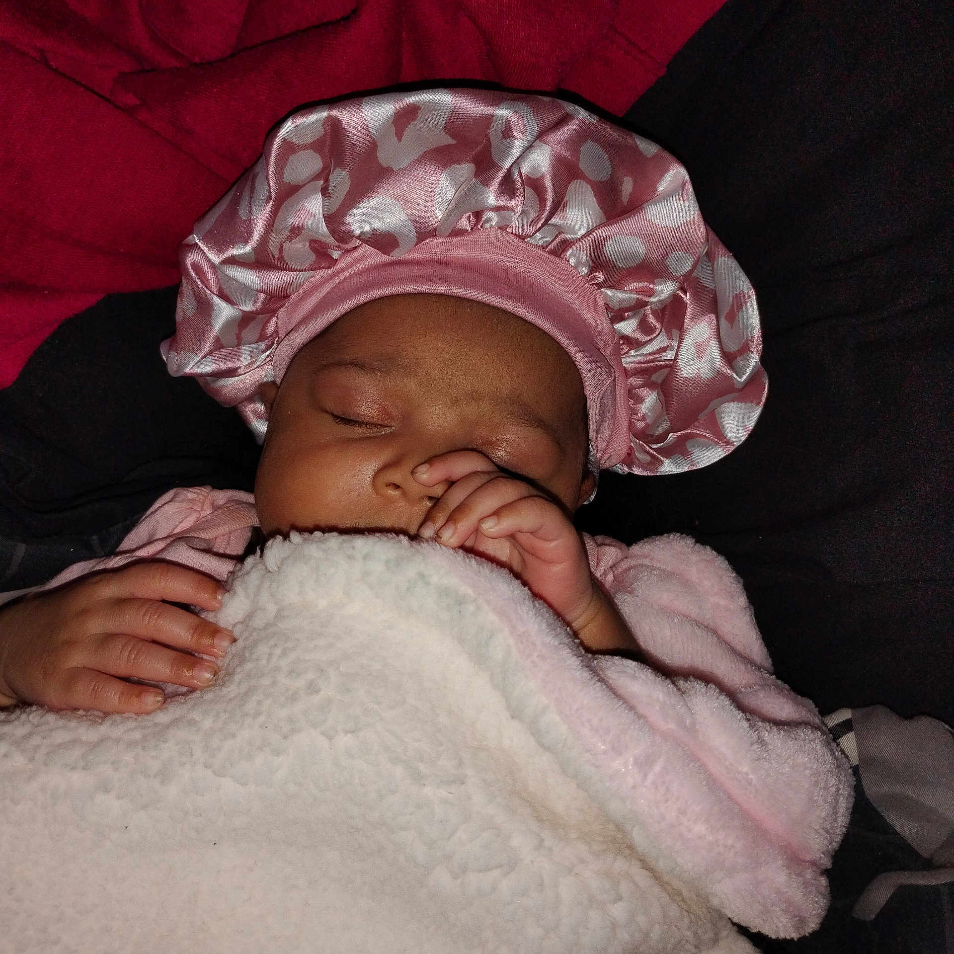 Zora is registered to the contest to win money with this photo: baby, sleeping, blanket, pink, bonnet, hand, face, cozy, soft, infant, cute, child, rest, warm, wrapped, peaceful, portrait, indoor, closeup, newborn