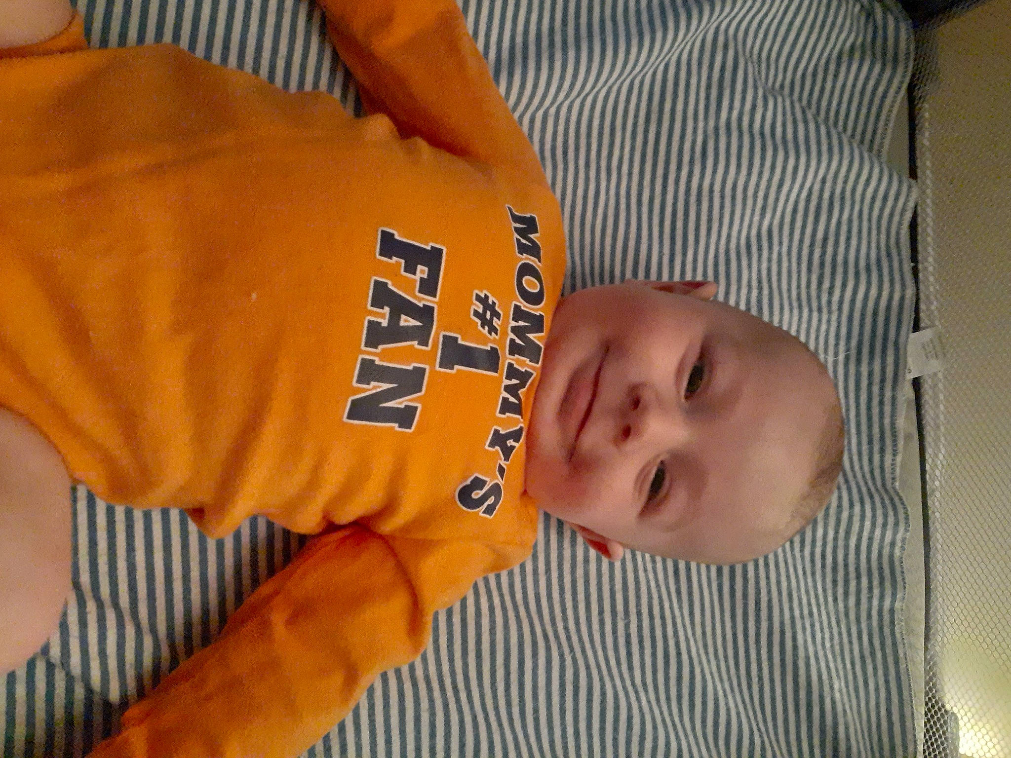 Jaden is registered to the contest to win money with this photo: baby, baby_toddler_clothing, cheek, child, chin, comfort, elbow, fun, happy, joy, orange, pattern, person, sleeve, smile, thumb, toddler, vertebrate, wood, wrist