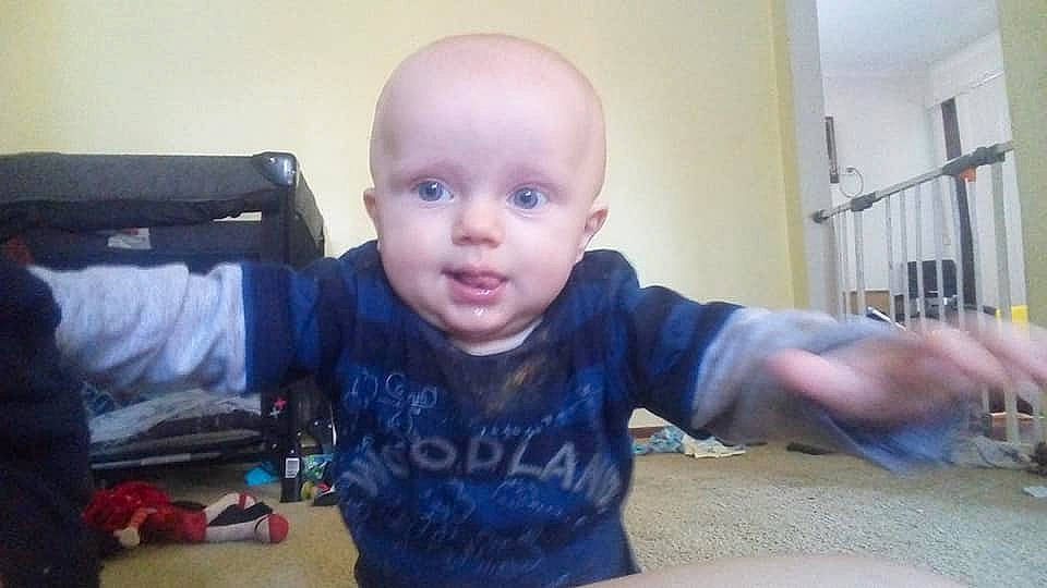 Kacey is registered to the contest to win money with this photo: arm, baby, cheek, child, ear, eye, eyebrow, face, finger, forehead, head, mouth, nose, person, play, sitting, skin, smile, toddler